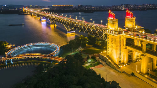 High angle view of illuminated buildings in city at night