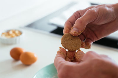 Young man making cookies at the kitchen