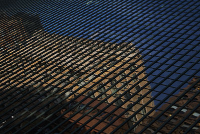 Full frame shot of reflection of modern building against sky