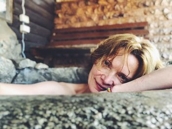 Portrait of woman lying on floor