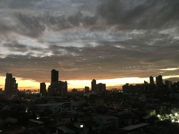 High angle view of buildings against cloudy sky during sunset