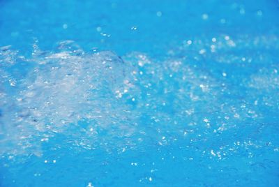 Close-up of bubbles in blue water