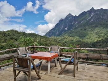 Chairs and table against mountains