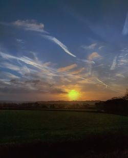 Scenic view of field against sky during sunset