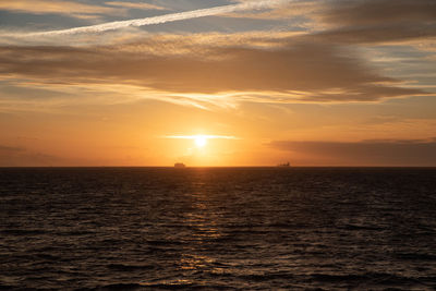 Ships sailing in the mediterranean sea with a sunset