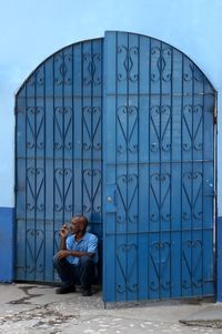 Man with text on blue wall