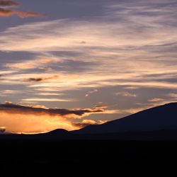 Scenic shot of silhouette mountains against sunset sky