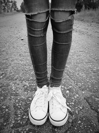 Low section of woman standing on street