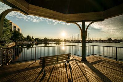The sun shines during morning into the wooden pergola located on the humber bay waterfront