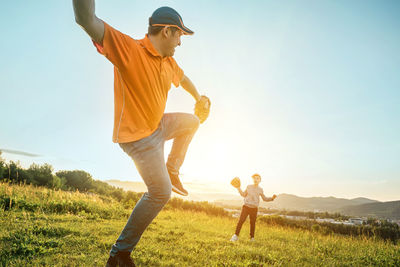 Father and son playing in baseball. man teaching boy baseballs exercise. family sports father's day.