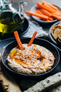 Delicious hummus with paprika, olive oil and some bread to dip