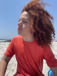 Portrait of young boy sitting at beach