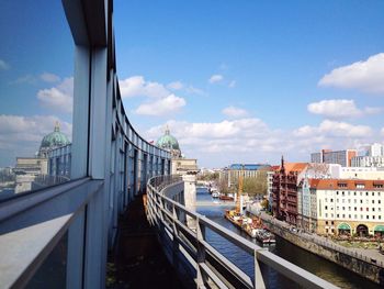 Bridge over cityscape against sky