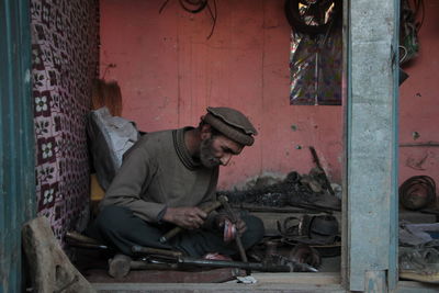 Blacksmith working in workshop