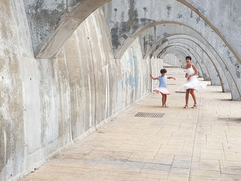 Mother and daughter dancing in arcade