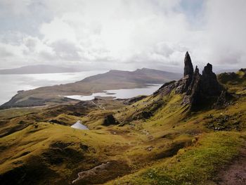 Scenic view of mountains against cloudy sky