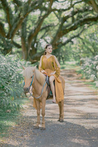 Portrait of woman standing on road