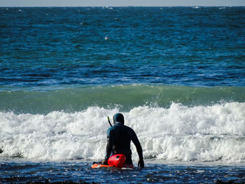 Rear view of man in sea