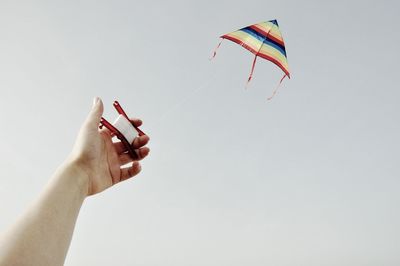 Cropped image of hand holding cigarette