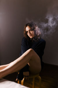 Woman sitting on a chair in black sweater