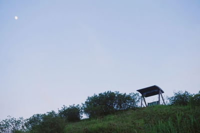 Gazebo on landscape against clear sky