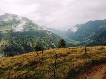 Scenic view of landscape and mountains against sky