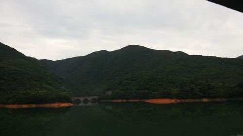Scenic view of mountains against cloudy sky