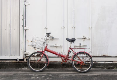 Bicycle parked against wall