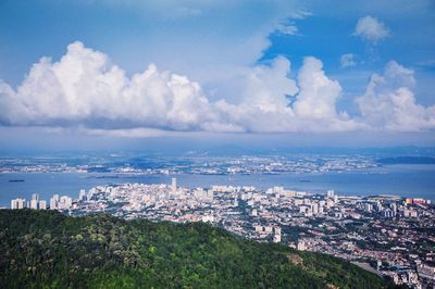 High angle view of townscape by sea against sky