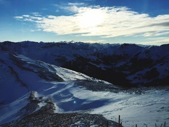 Scenic view of snow covered mountains against sky