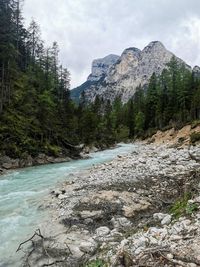 Scenic view of river amidst mountains against sky