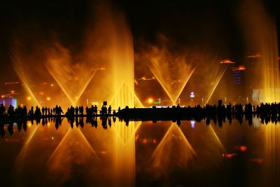 Reflection of illuminated lights in water at night
