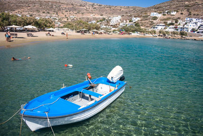 Boats in sea against blue sky