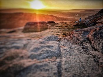 Rock formation on land against sky during sunset