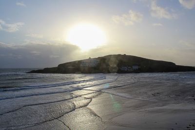 Scenic view of beach against sky during sunset