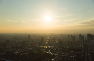 High angle view of modern buildings against sky during sunset