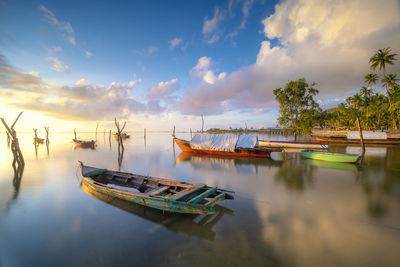 Boats moored in sea against sky