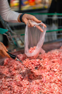 Cropped hand holding meat at market