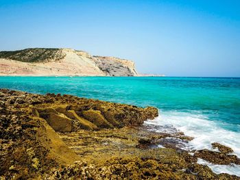 Scenic view of sea against clear blue sky