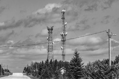 Low angle view of electricity pylon against sky