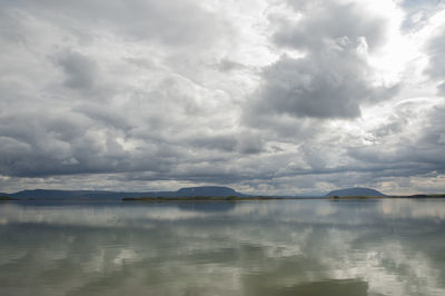 View of calm sea against cloudy sky