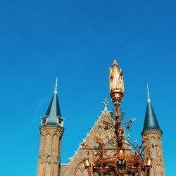 Low angle view of built structure against clear blue sky