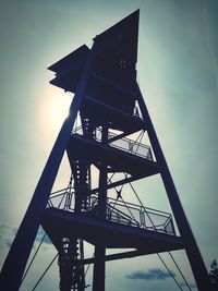 Low angle view of silhouette tower against sky