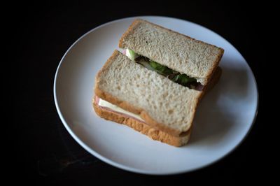 Sandwiches with egg, ham and toast cheese fried in white dish