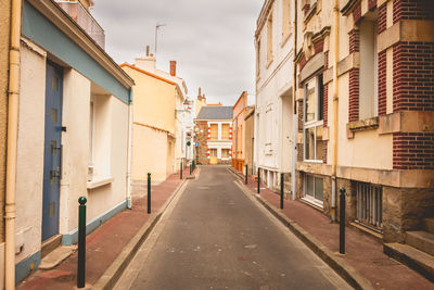 Empty alley amidst residential buildings