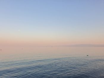 Scenic view of sea against clear sky during sunset