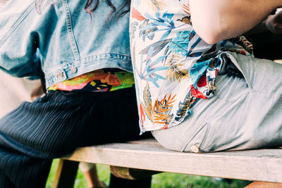 Low section of woman sitting outdoors