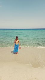 Full length of young boy standing on beach