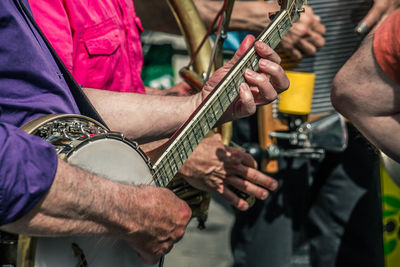 Close-up of man playing guitar