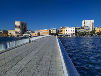 View of river and buildings against clear sky